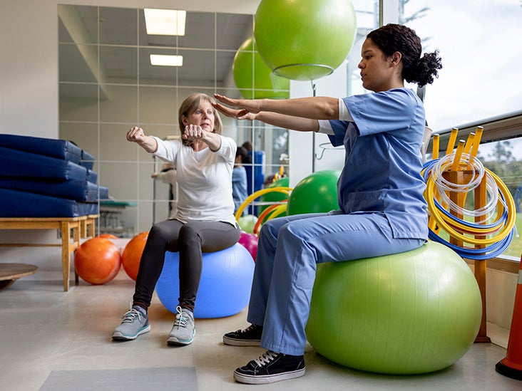 Physiotherapist supporting balance and coordination exercises